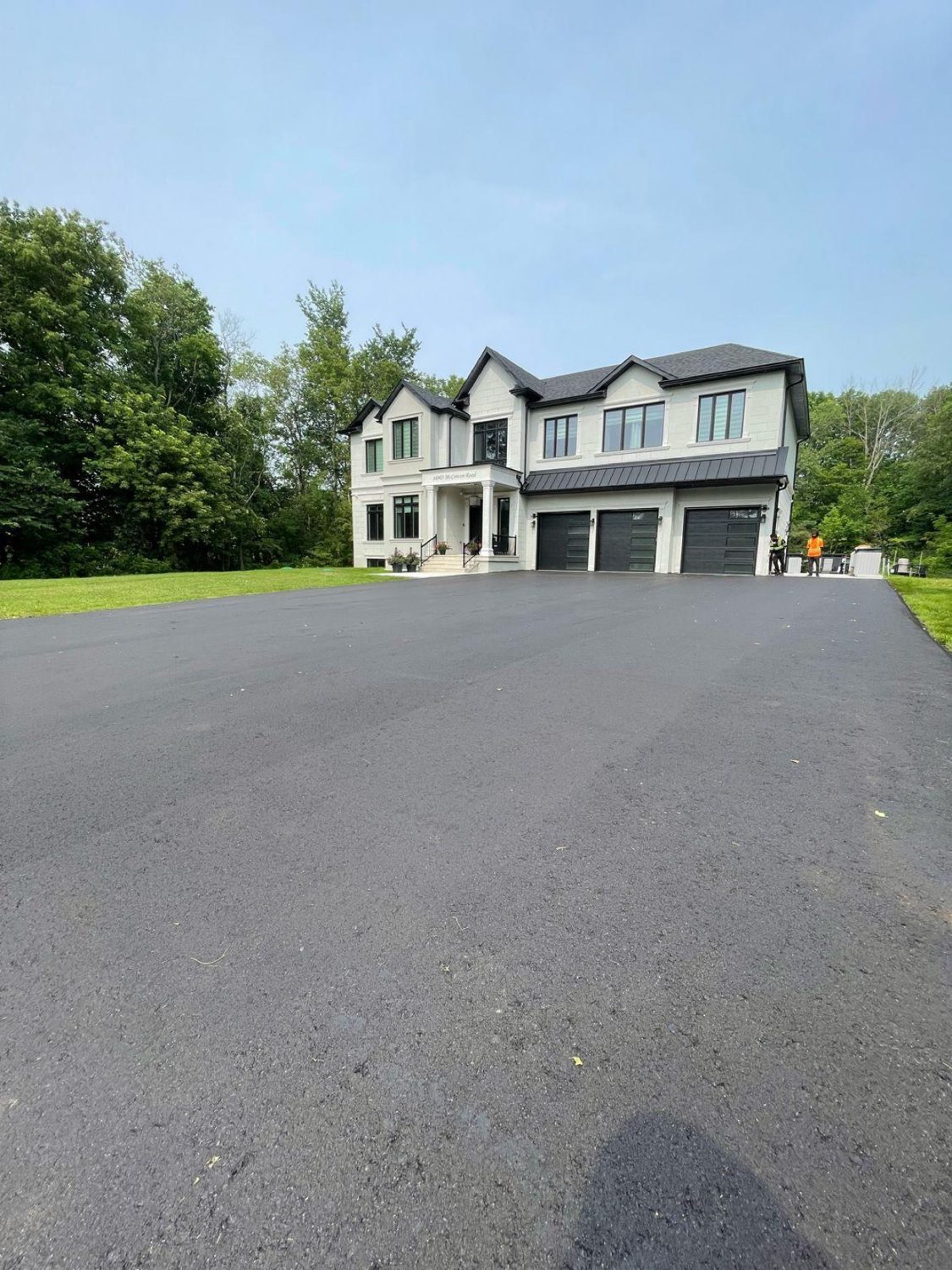Fresh Next Gen Paving asphalt driveway in front of a luxury GTA home