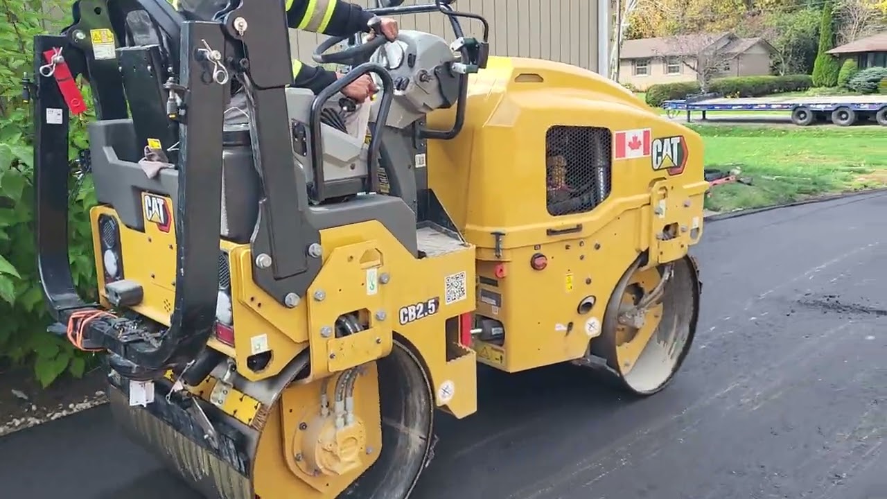 Next Gen Paving CAT roller compacting fresh asphalt on a GTA driveway